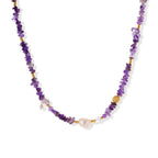 Beaded necklace with purple amethyst chips, freshwater pearls, and gold accents on white background.