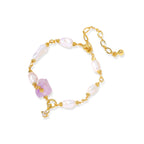Gold-plated bracelet with lustrous baroque pearls and raw lavender amethyst centerpiece on white background.