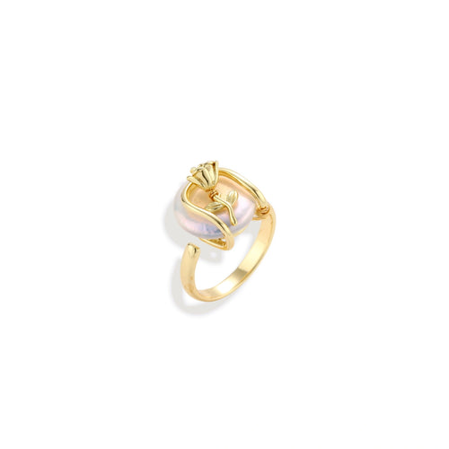 Gold-plated sculptural ring featuring a baroque pearl wrapped in a delicate rose and vine cage design