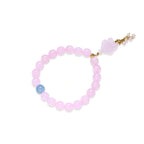 Stretchy beaded bracelet with pink rose quartz, blue aquamarine, carved floral pendant, and pearl tassel clasp.