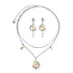 Delicate eco-brass jewelry set featuring gold star and silver moon crescents with clear zirconia crystal drops on cream background
