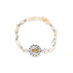 Stretchable bracelet with cream citrine stone chips, brass beads, and central amber zirconia pendant on neutral background.
