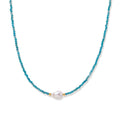 Delicate gold vermeil necklace with teal apatite beads and freshwater pearl on white background.