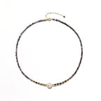 Dainty necklace with faceted purple iolite beads, gold vermeil accents, and central pink-white freshwater pearl.