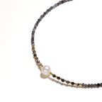 Dainty necklace with faceted purple iolite beads, gold vermeil accents, and central pink-white freshwater pearl.