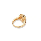 Teardrop-shaped gold-plated ring with turquoise enamel flowers and crystal pavé detail on cream background