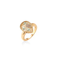 Teardrop-shaped gold-plated ring with turquoise enamel flowers and crystal pavé detail on cream background