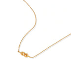 Dainty 18K gold plated necklace with infinity knot pendant on delicate chain against white background