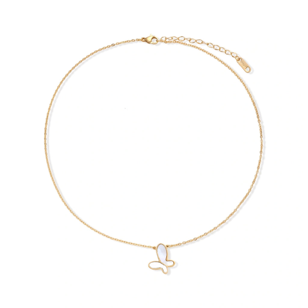 Gold-plated butterfly pendant with iridescent mother of pearl inlay on delicate chain against cream background.