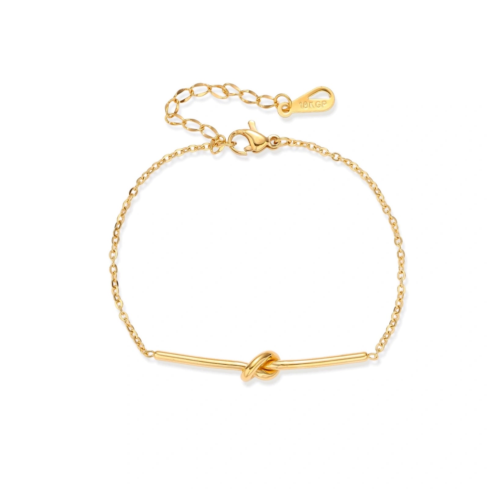 Delicate gold chain bracelet with minimalist bar and centered knot detail on cream background