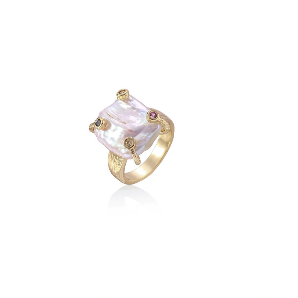 Gold ring with large iridescent baroque pearl and four colored gemstones on textured band