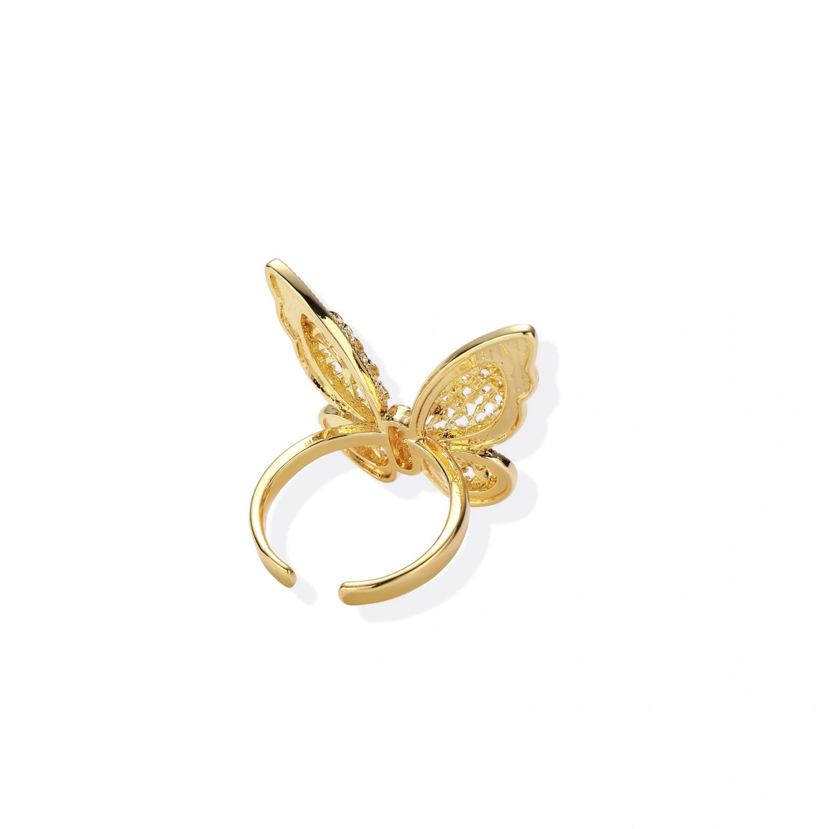 Intricate gold-plated butterfly ring with filigree cutout wings and adjustable band on white background.