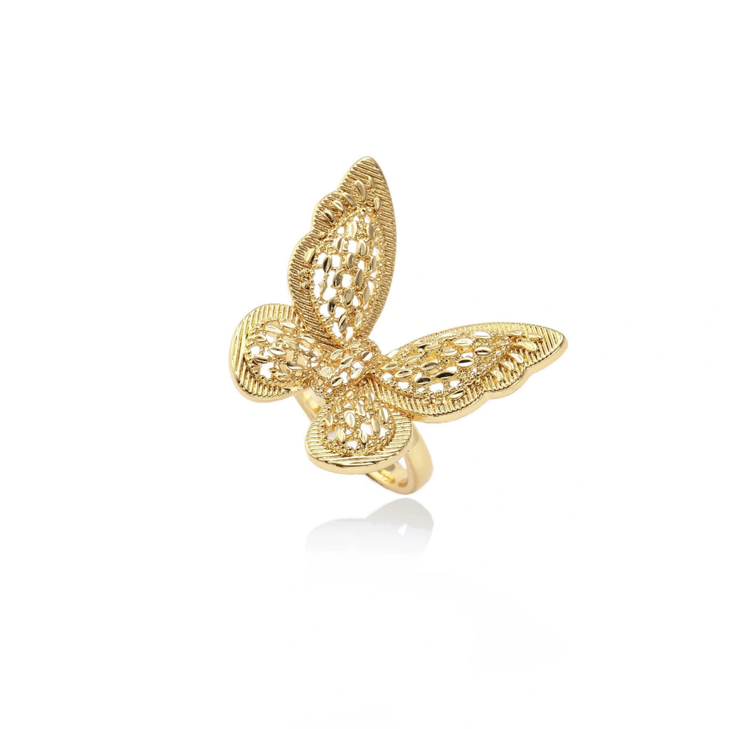 Intricate gold-plated butterfly ring with filigree cutout wings and adjustable band on white background.