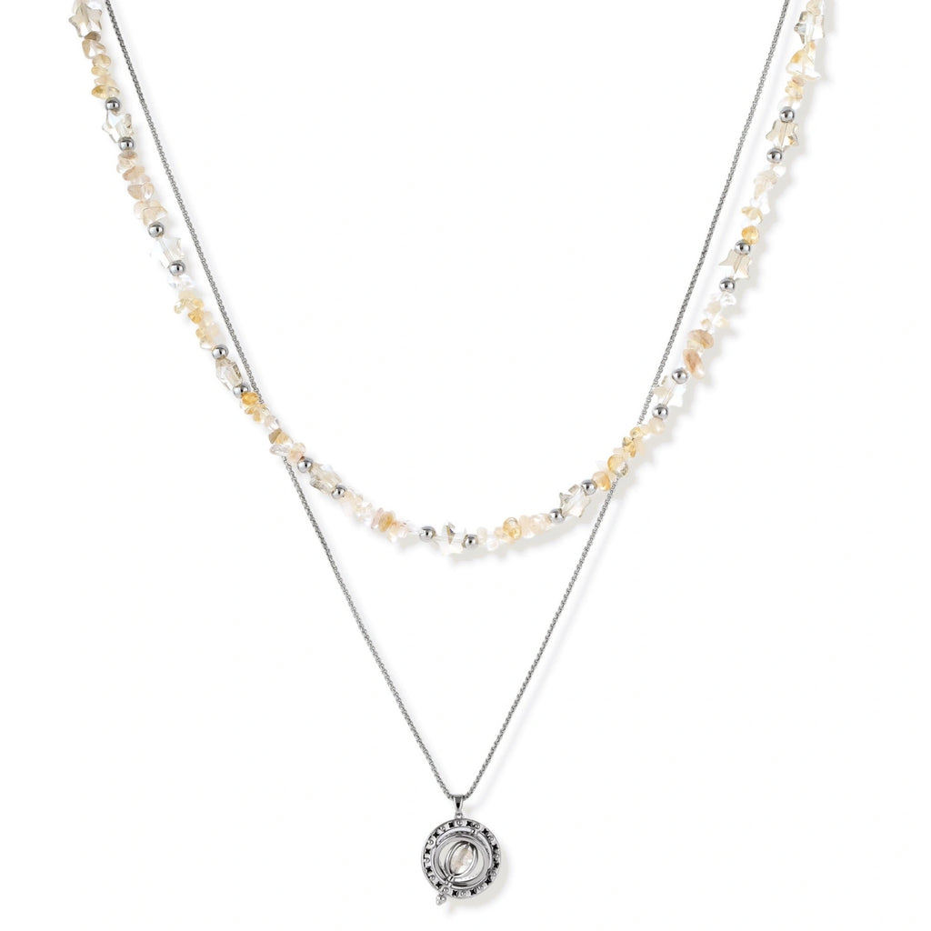 Complete jewelry set featuring citrine stone chips, silver beads, and cosmic circle pendants on cream background.