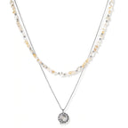 Complete jewelry set featuring citrine stone chips, silver beads, and cosmic circle pendants on cream background.