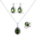 White gold plated jewelry set with green teardrop gemstones and cubic zirconia halos on cream background.