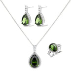 White gold plated jewelry set with green teardrop gemstones and cubic zirconia halos on cream background.