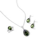 White gold plated jewelry set with green teardrop gemstones and cubic zirconia halos on cream background.