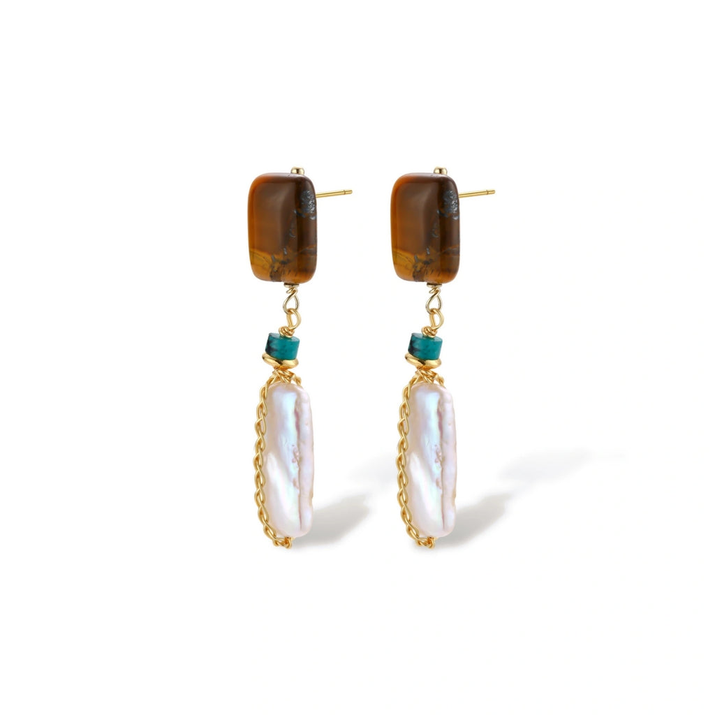 Gold-plated drop earrings with amber stones, teal beads, and wire-wrapped baroque pearls on cream background.